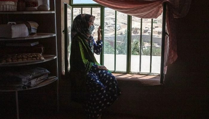 1 de 1 Menina do Afeganistão olha pela janela - Foto: Sayed Habib Bidell/ ONU mulheres